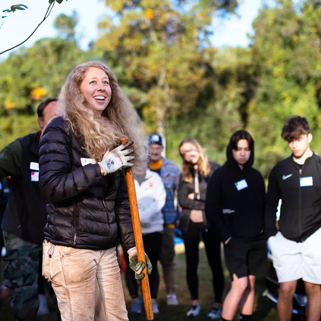 Woman smiling at a crowd of people