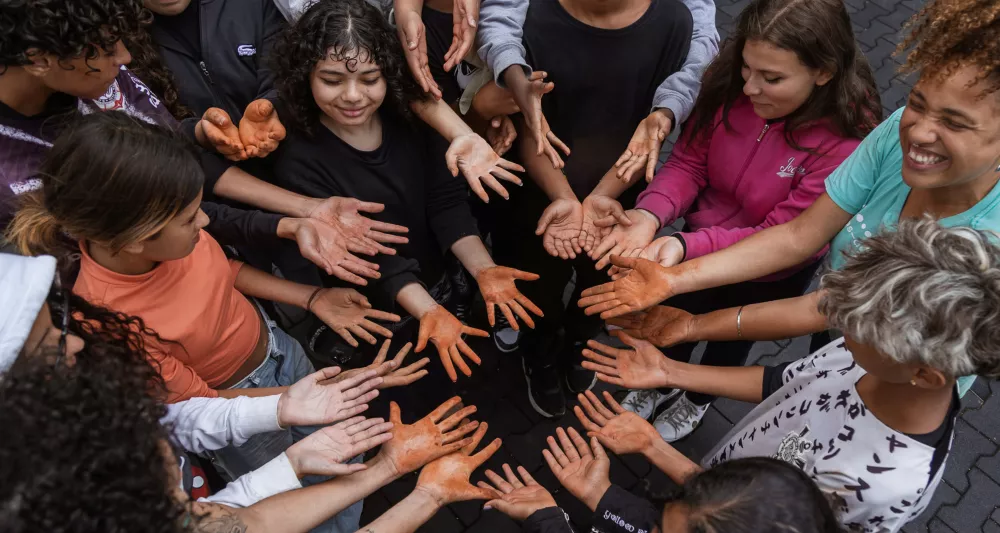 people in circle with dirty hands