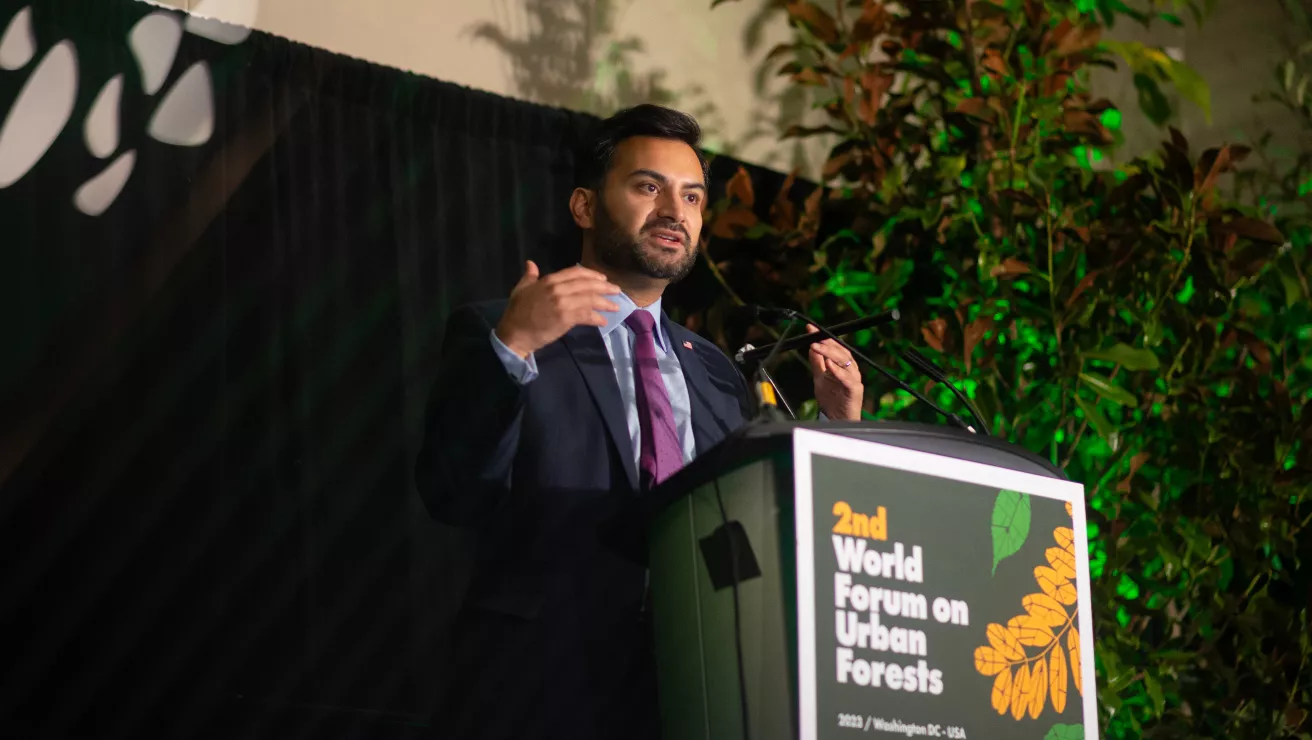speaker at a podium at World Forum on Urban Forestry