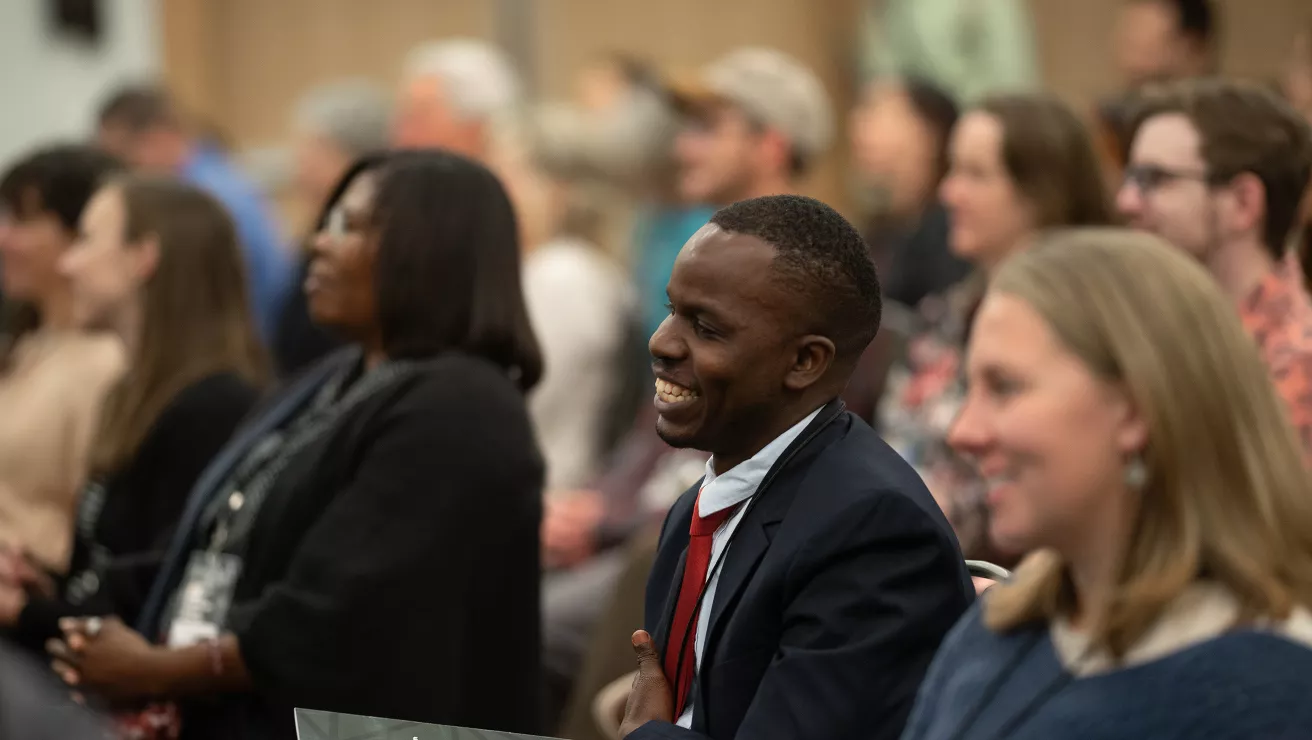 crowd of smiling people in a conference