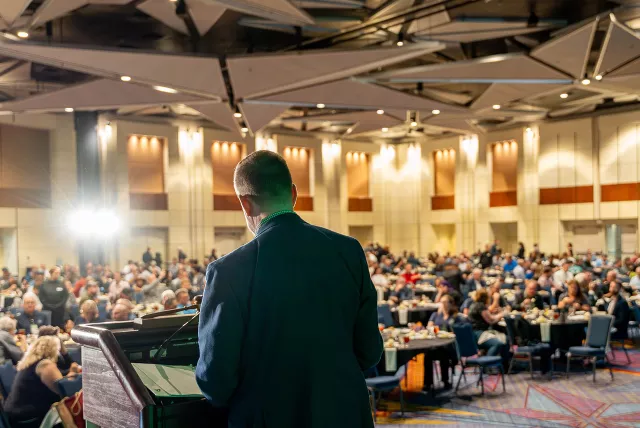 speaker addressing a large crowd at Trees & Utilities Conference 2024