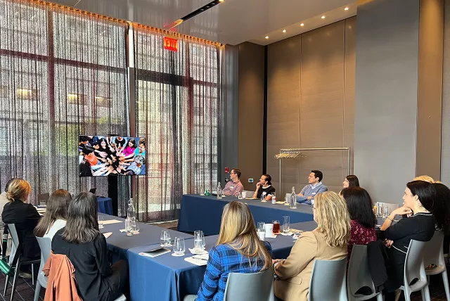 Members of the Evergreen Alliance sitting in a boardroom watching a video