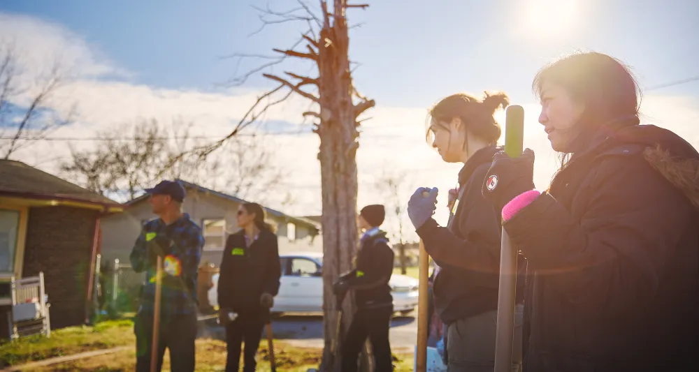 volunteers planting a tree in underserved neighborhood