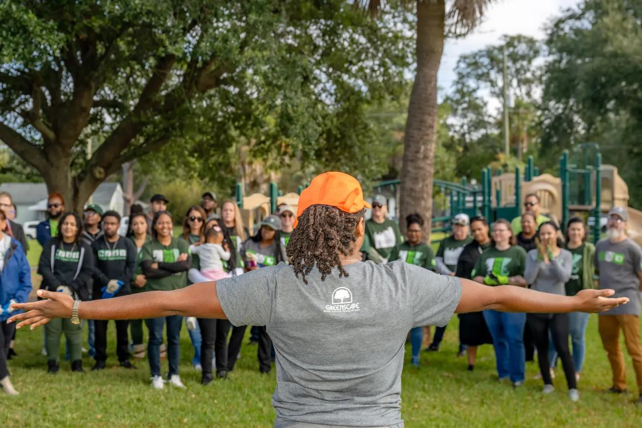 community tree planting partner speaking to large group of volunteers.