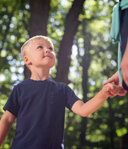 little boy holding sister's hand