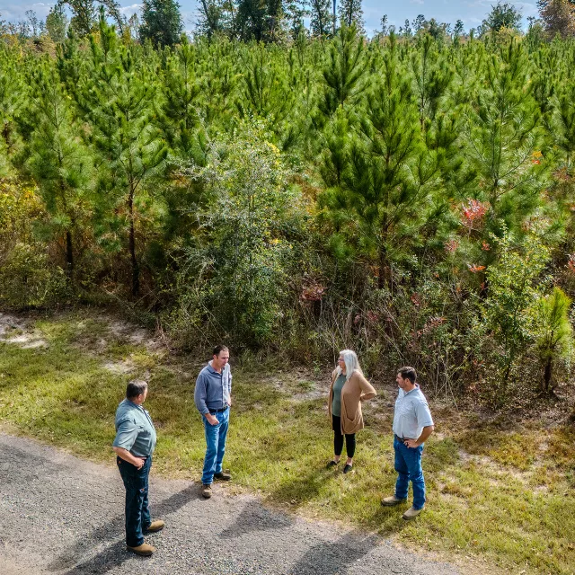landowners conversing by forest