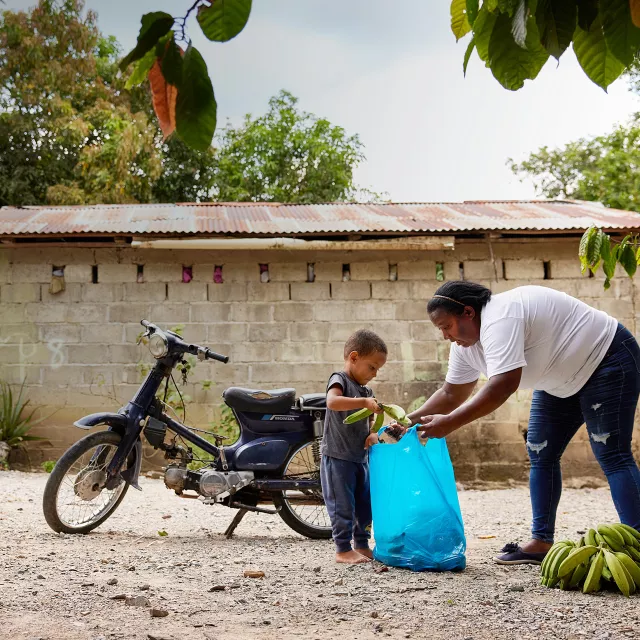 woman and son packing bananas for market