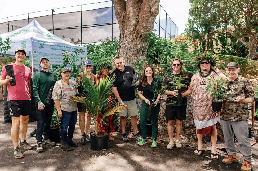Group of tree planters standing in front of tree in Hawaii.
