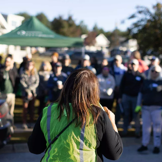 partner or official addressing crowd of volunteers